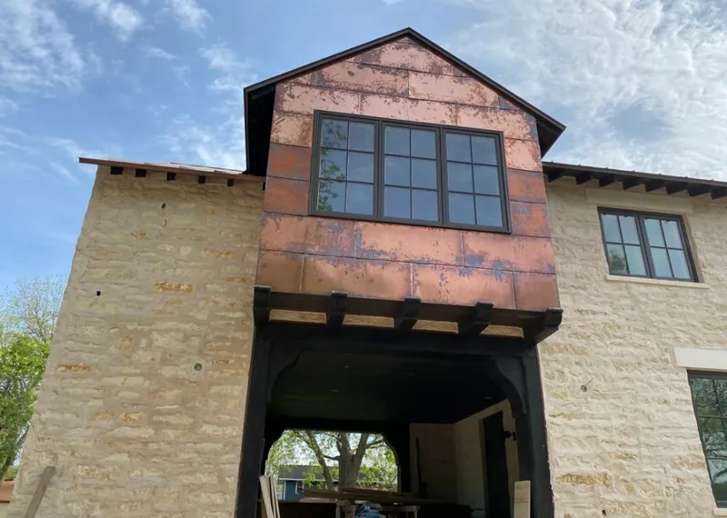Copper metal panel facade on a stone building for Skylight Installation in Jeannette